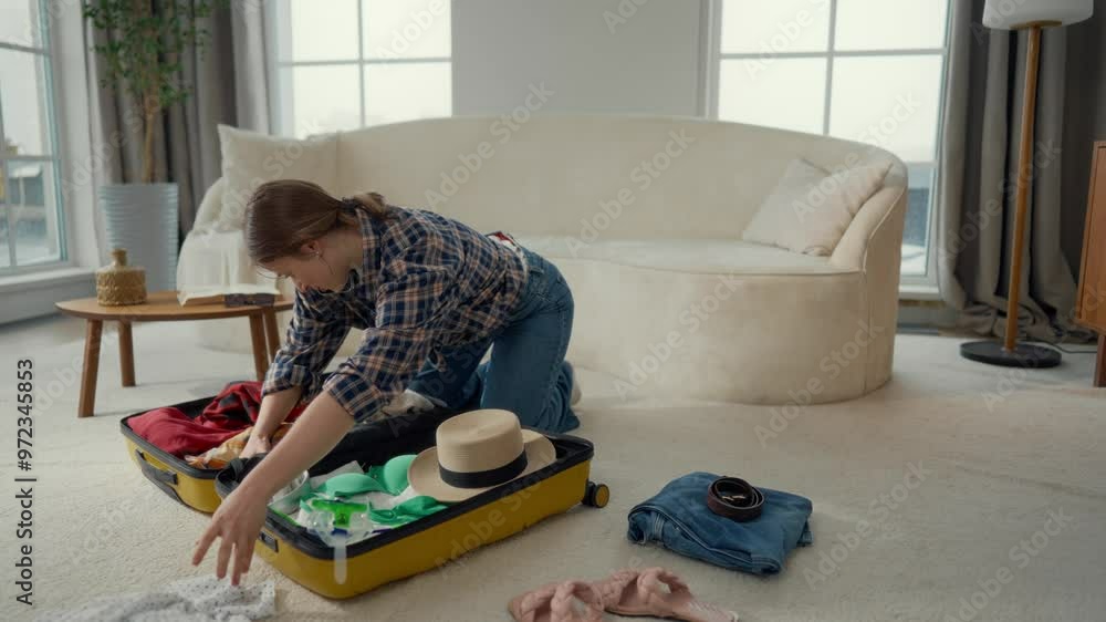 Pretty female traveller preparing to trip in summer vacation, calling by phone. Portrait of Caucasian student girl packaging suitcase in living room, dream about seacoast, travel and tourist concept Pretty female traveller preparing to trip in summer vacation, calling by phone. Portrait of Caucasian student girl packaging suitcase in living room, dream about seacoast, travel and tourist concept
