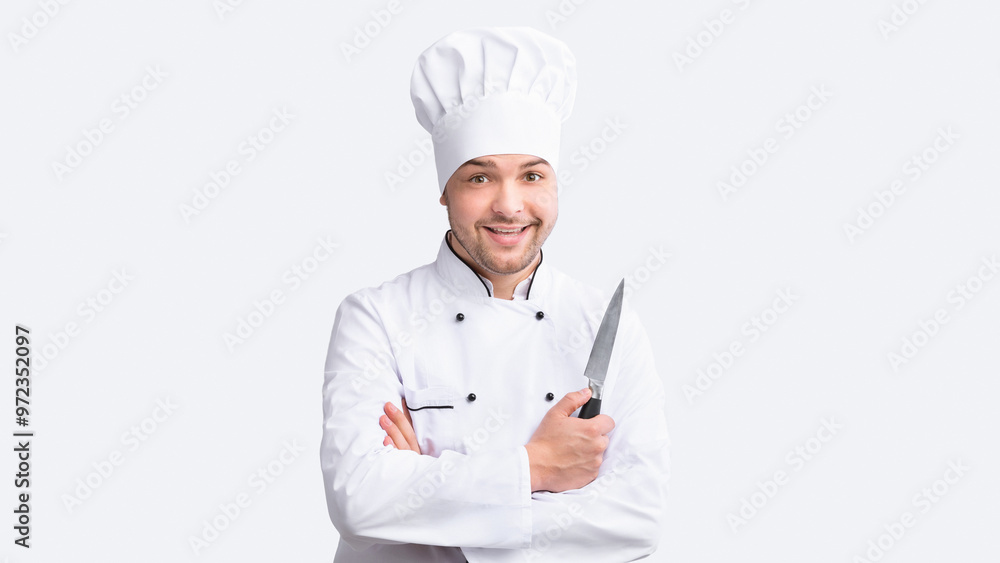 Positive Cook Man Holding Kitchen Knife Posing Standing Over White Background. Cooking Food Concept. Studio Shot Positive Cook Man Holding Kitchen Knife Posing Standing Over White Background. Cooking Food Concept. Studio Shot