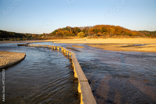 Yeongju-si, Gyeongsangbuk-do, South Korea - November 3, 2020: High angle view of Single Wooden Bridge on Naeseongcheon Creek at Museom Village in autumn