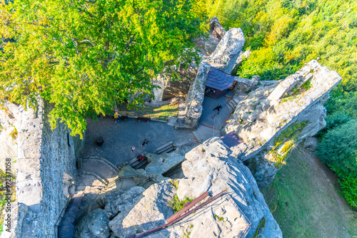 Frydstejn Castle ruins stand majestically, surrounded by lush greenery. Visitors explore the historic site while enjoying stunning views of the Bohemian Paradise in Czechia. photo