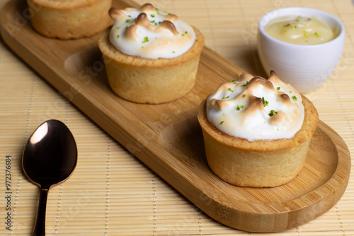 Baked tartlets with white cream, delicious dessert photo