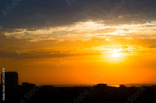 Sun over the Roofs of a Seaside Town and the Sea Horizon