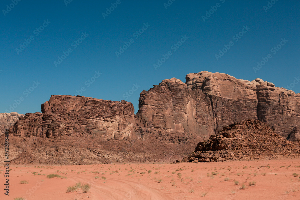 Explore the stunning rock formations and vast landscape of Wadi Rum Desert in Jordan during a clear day Explore the stunning rock formations and vast landscape of Wadi Rum Desert in Jordan during a clear day