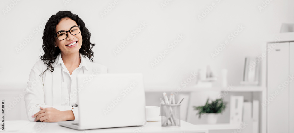 Happy Mexican Accountant In Glasses Working At Modern Office And Looking At Camera. Copy space Happy Mexican Accountant In Glasses Working At Modern Office And Looking At Camera. Copy space