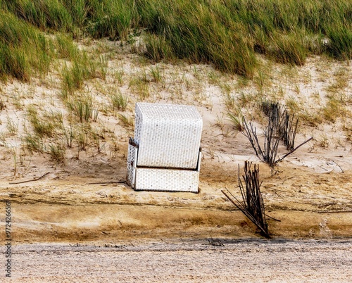 Obraz na płótnie
Beach chair washed into the dunes by the storm w salonie