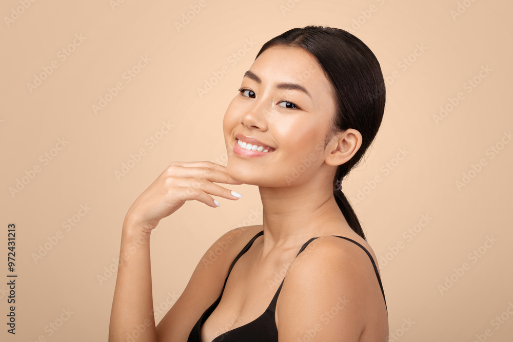 Facial Beauty Care. Portrait Of Happy Japanese Young Lady Touching Her Face And Chin Skin Over Gray Background In Studio, Smiling To Camera. Woman Advertising Double Chin Treatment Concept Facial Beauty Care. Portrait Of Happy Japanese Young Lady Touching Her Face And Chin Skin Over Gray Background In Studio, Smiling To Camera. Woman Advertising Double Chin Treatment Concept