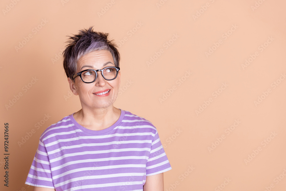Photo of lovely adorable pensioner woman wear striped stylish clothes empty space banner isolated on beige color background Photo of lovely adorable pensioner woman wear striped stylish clothes empty space banner isolated on beige color background