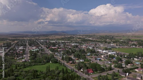 Panoramic aerial establish of Pinedale, Wyoming, with its town layout set against the vast plains and rolling hills photo