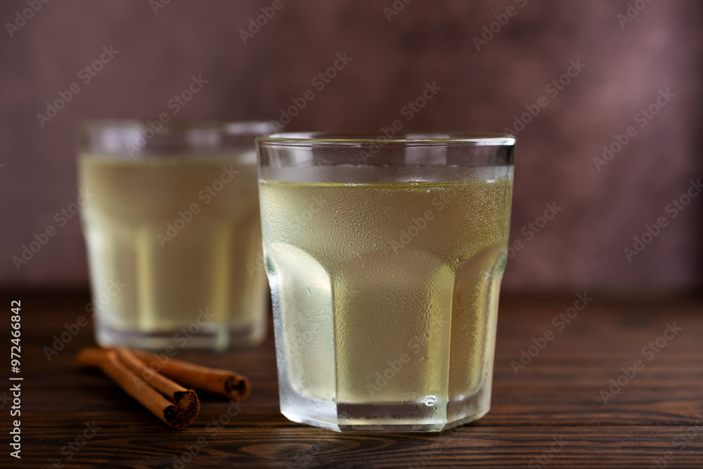 Pineapple kvass Tepache in a glasses on a brown wooden table. Fermented, probiotic drink. Pineapple kvass Tepache in a glasses on a brown wooden table. Fermented, probiotic drink.