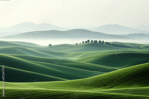 A serene landscape of rolling green hills under a soft morning mist, creating a peaceful and tranquil natural scene.