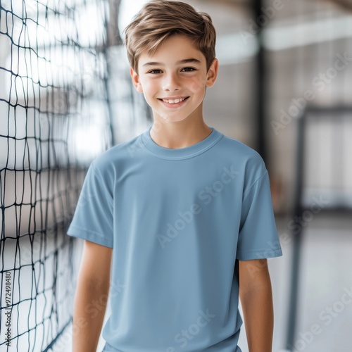 Sports kids tshirt mockup. Boy model standing near volleyball net. Blue Bella canvas 3001 mock up. School aged child mockup. Children's casual shirt mock. Short sleeve tee, blank shirt template 