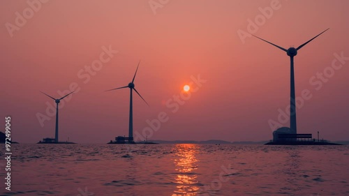 Tando Port View During Pink Sunset Over Industrial Wind Turbines With Stoped Rotating Due to Windless Weather, Sun Setting Over Sea - Static Low Angle View photo