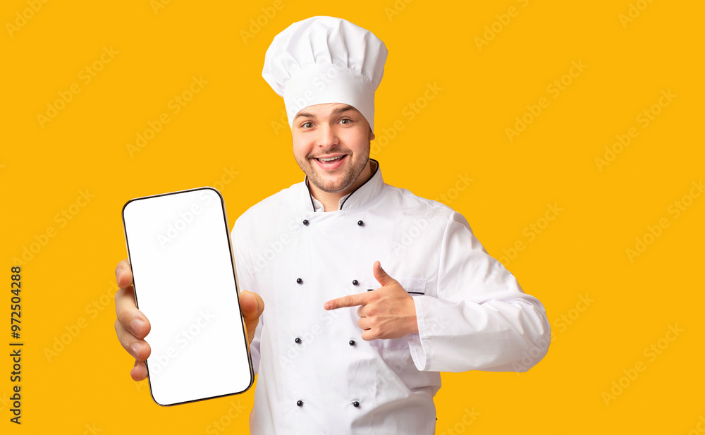Positive Chef Man Pointing Finger Showing Empty White Board In His Hands Standing Over Yellow Studio Background. Mockup Positive Chef Man Pointing Finger Showing Empty White Board In His Hands Standing Over Yellow Studio Background. Mockup