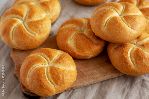 Photos Homemade Kaiser Rolls on a wooden board, side view.