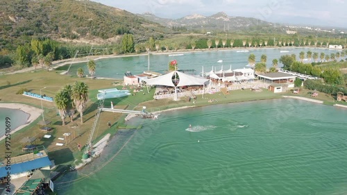 Aerial drone footage of Hip-Notics Cable Park in Antalya, Turkey. Wakeboarding destination in Europe. Wakeboarding on a crystal clear green lake, wakeboard tricks and features of the wake park. photo