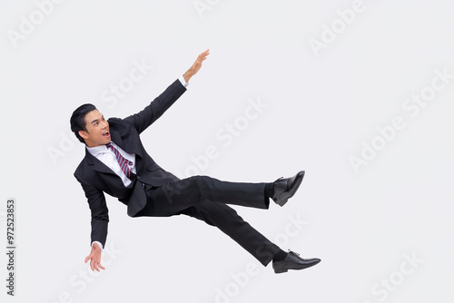 A young asian businessman blown away by a explosive force or strong wind. Flung to the left. Isolated on a white background.