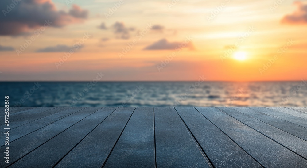 A serene sunset over the ocean viewed from a wooden deck. A serene sunset over the ocean viewed from a wooden deck.