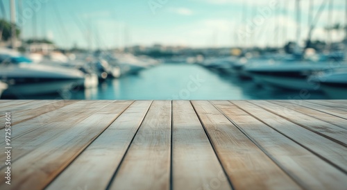 A serene view of a marina with boats and a wooden deck in the foreground.