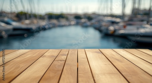 A wooden table in the foreground with a marina and boats in the background.