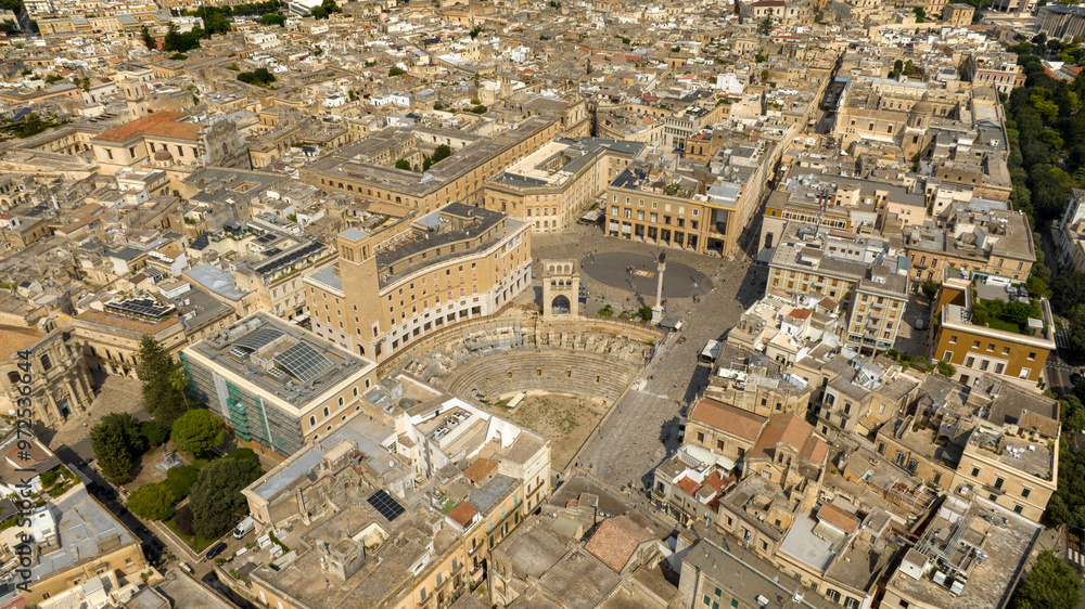 Fototapeta premium Aerial view of Sant'Oronzo square and the Roman amphitheater of Lecce, In Puglia, Italy. It is for the people of Lecce the main meeting place, entertainment and privileged location for shows.