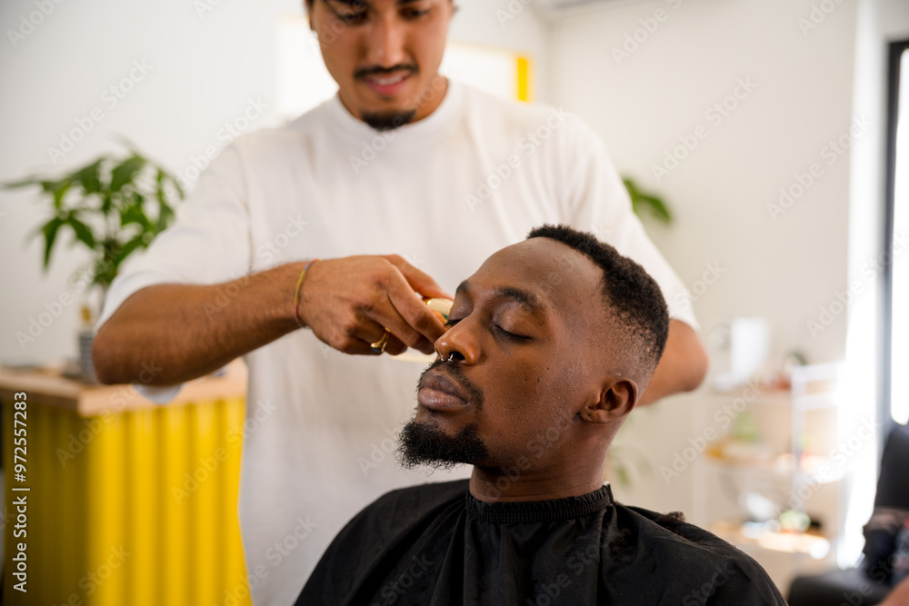 Black man receiving professional grooming in a barber shop Black man receiving professional grooming in a barber shop