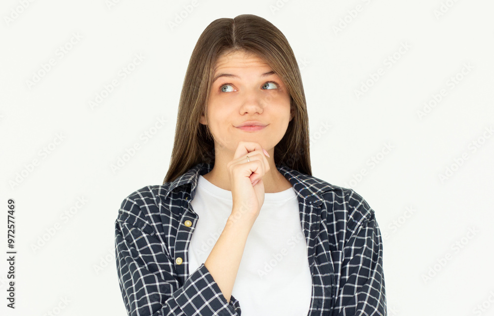 Cute woman thinking about smth. Young brunette student girl is thoughtful on white background Cute woman thinking about smth. Young brunette student girl is thoughtful on white background