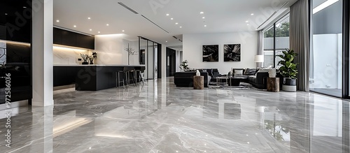Obraz na płótnie Modern open-plan area featuring light grey marble flooring and stylish black furniture. w salonie