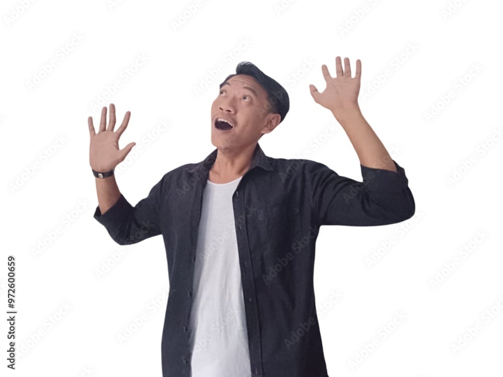 Surprised young handsome Asian man looking upward with raised hands isolated on white background Surprised young handsome Asian man looking upward with raised hands isolated on white background