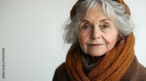 An elderly woman radiates wisdom and warmth while contemplating in her cozy attire