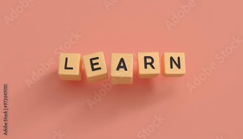 Colorful blocks spelling the word 'LEARN' on a soft pink background, symbolizing education and growth in learning.