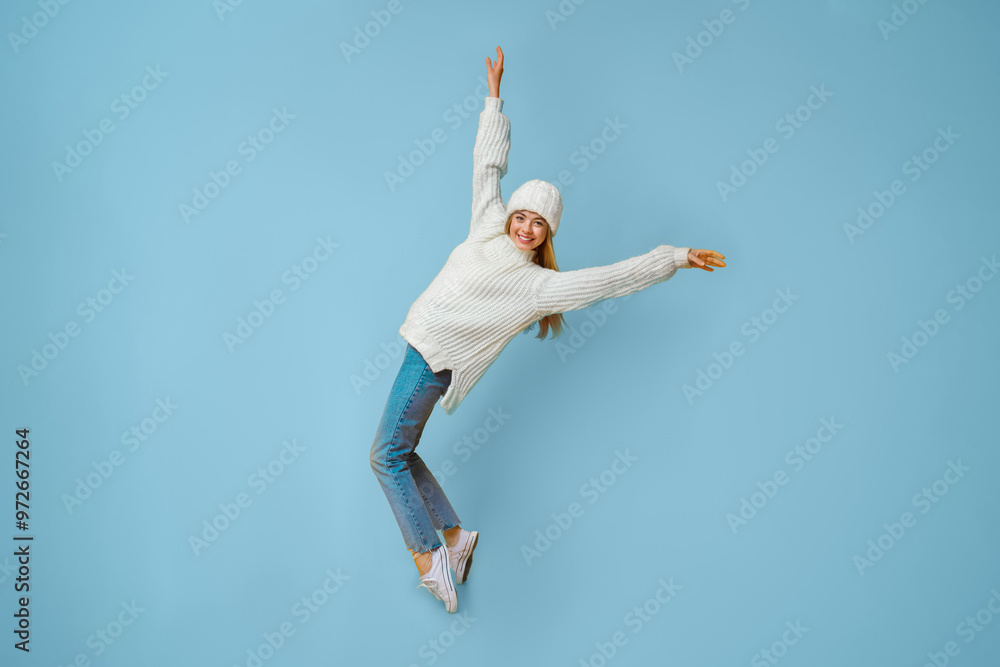 Φωτογραφία Carefree winter girl dancing, standing on her toes, leaning backward, yellow bac