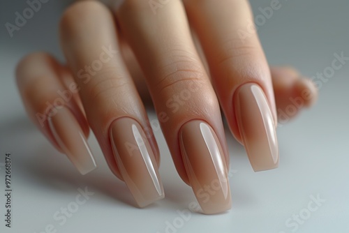 Elegant woman's hands showcasing chic neutral nail art against a soft background, highlighting a contemporary style in personal grooming