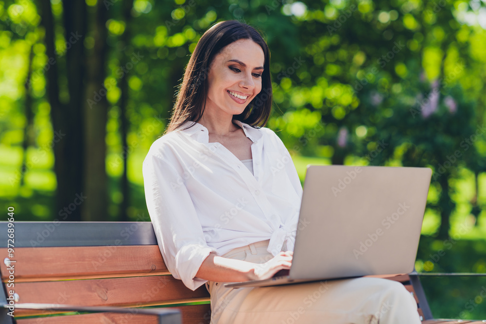 Photo of young cheerful woman sit bench work netbook wear white outfit walk park sunny summer weather outside