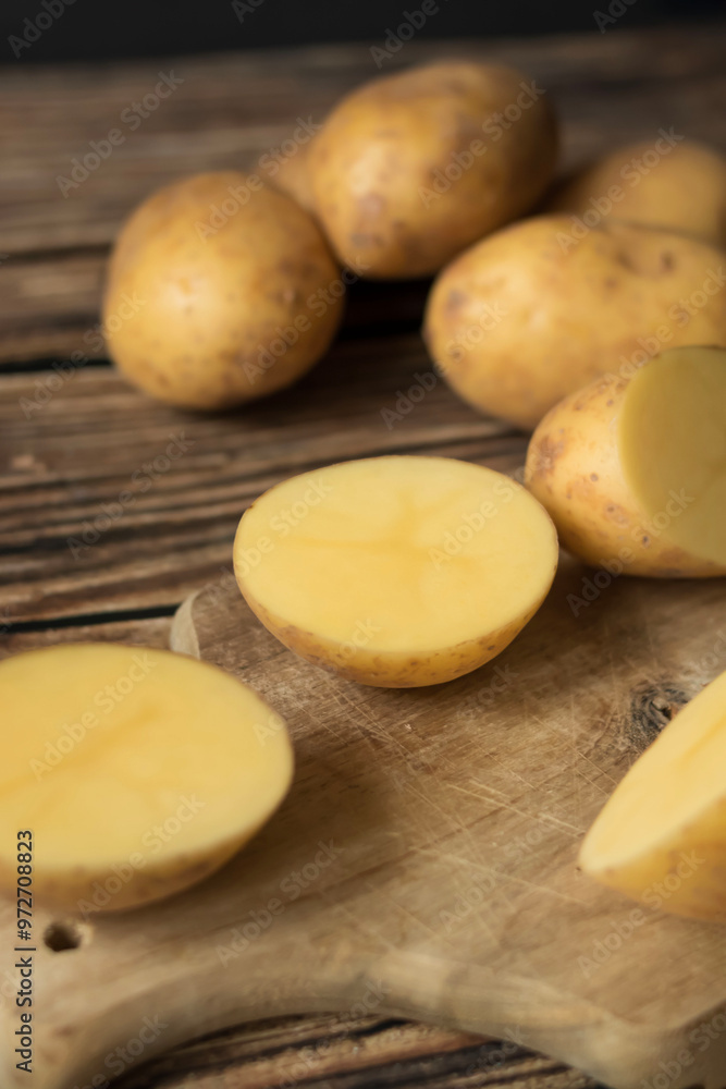 young raw potato. on a dark wooden background. food young raw potato. on a dark wooden background. food
