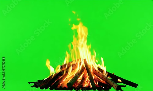 Logs crackle as flames rise on a vivid green screen, ideal for creating a realistic fire effect in video projects