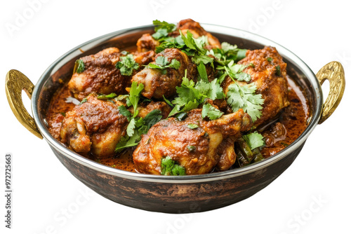 Aromatic chicken curry with fresh herbs served in a traditional Indian-style copper pot