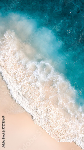 A Beautiful Aerial Drone View of a Quiet Sandy Beach with Gentle Waves, Ideal for a Soothing Phone Wallpaper