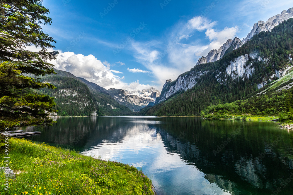 beautiful mountain lake on a sunny day in the alps of austria. A view of beautiful Austrian scenery. Snow-capped alpine mountains. beautiful mountain lake on a sunny day in the alps of austria. A view of beautiful Austrian scenery. Snow-capped alpine mountains.