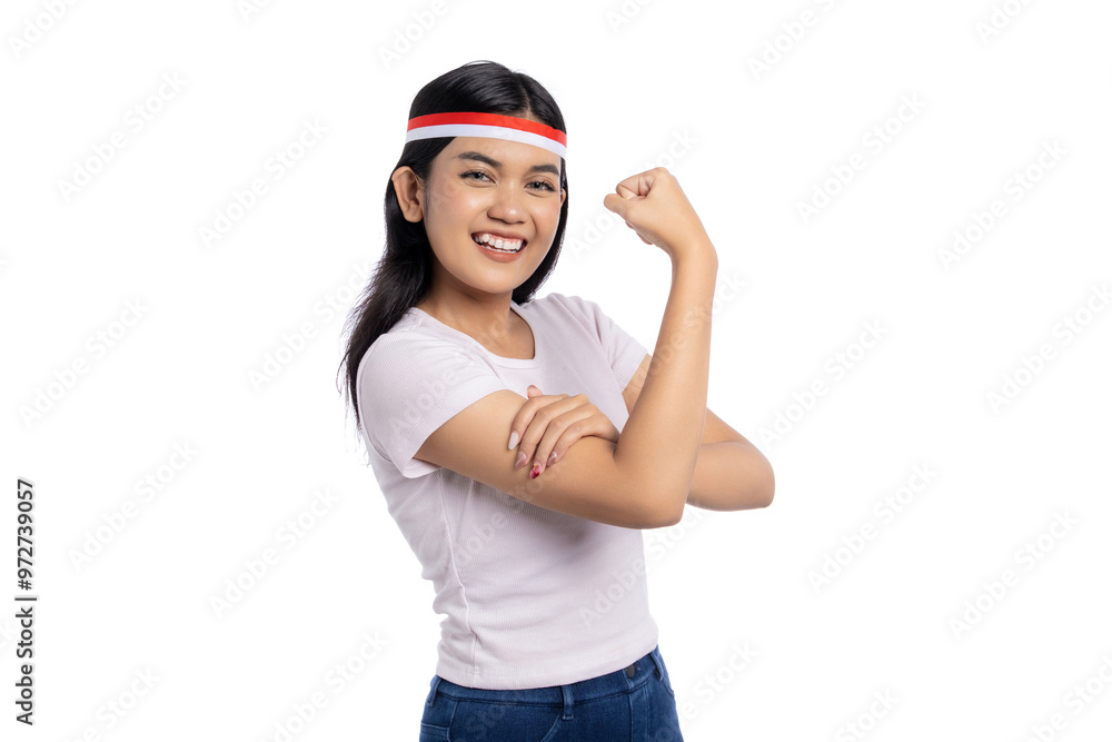 Excited young Asian woman showing strong arm gesture isolated on white background. Indonesian Independence Day Celebration Concept Excited young Asian woman showing strong arm gesture isolated on white background. Indonesian Independence Day Celebration Concept
