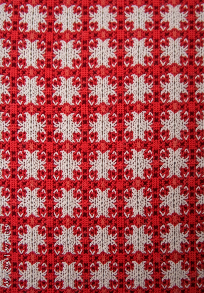Red and white checkered fabric made of a knitted material with a repeating pattern. Red and white checkered fabric made of a knitted material with a repeating pattern.
