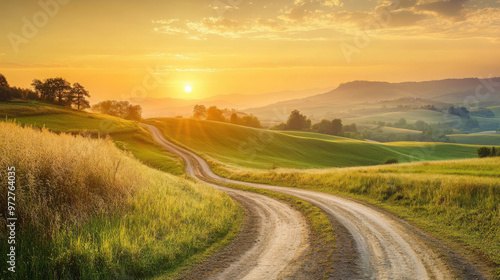 A tranquil countryside scene at sunrise, with a dirt road winding through rolling hills and the sun rising in the distance.