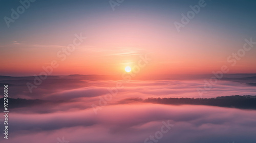 A breathtaking sunrise over a foggy valley, with the sun rising above the mist and the sky painted in soft pastel colors.