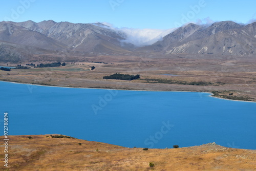 The stunning scenery and landscapes around the blue Lake Tekapo on the South Island of New Zealand photo