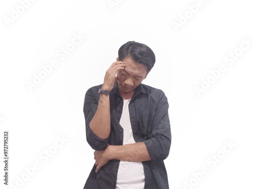 A man in a black shirt holds his head with a pained expression, indicating a headache or discomfort. The plain white background emphasizes his distress and highlights his posture and expression.