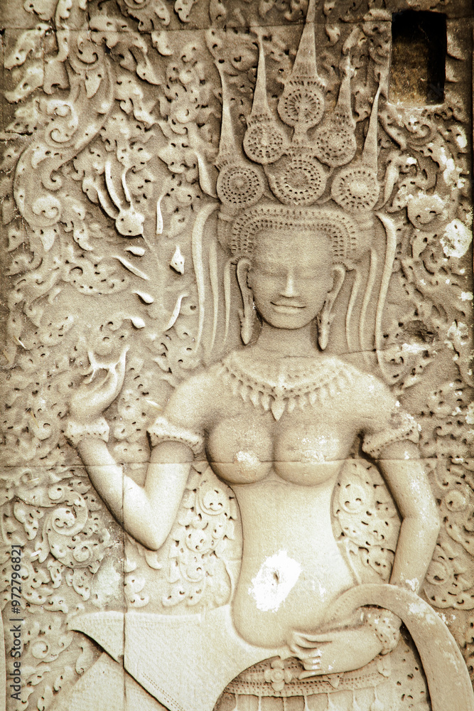Fototapeta premium Intricate stone carving of a celestial figure at Angkor Wat in Cambodia showcasing ancient artistry and cultural heritage