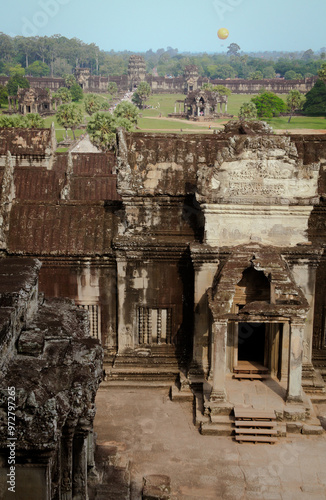 Exploring the majestic ruins of Angkor Wat in Cambodia during a clear day with lush greenery surrounding ancient stone structures