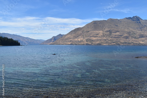 Walking along the Queenstown Gardens by the coastline of Lake Wakatipu on the South Island, New Zealand