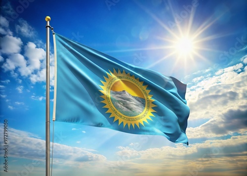 Vibrant South Dakota state flag waving in the wind against a bright blue sky with the sun shining photo