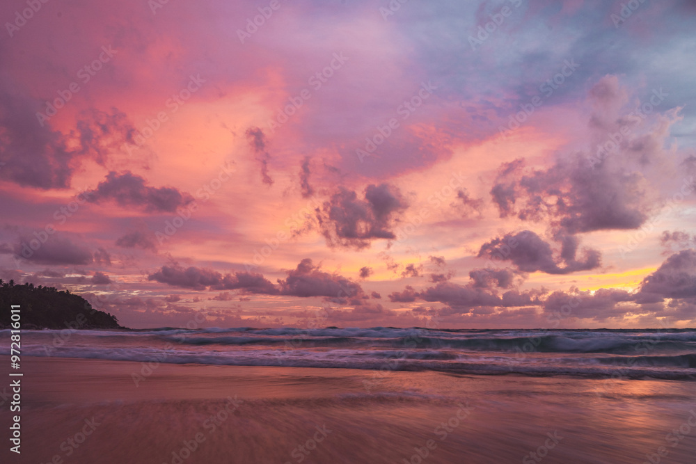 Obraz premium pink and orange sunset with clouds at karong beach in phuket