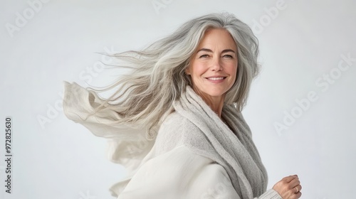 elegant mature woman in motion exuding confidence against clean white backdrop graceful pose and serene expression capture timeless beauty and vitality of aging